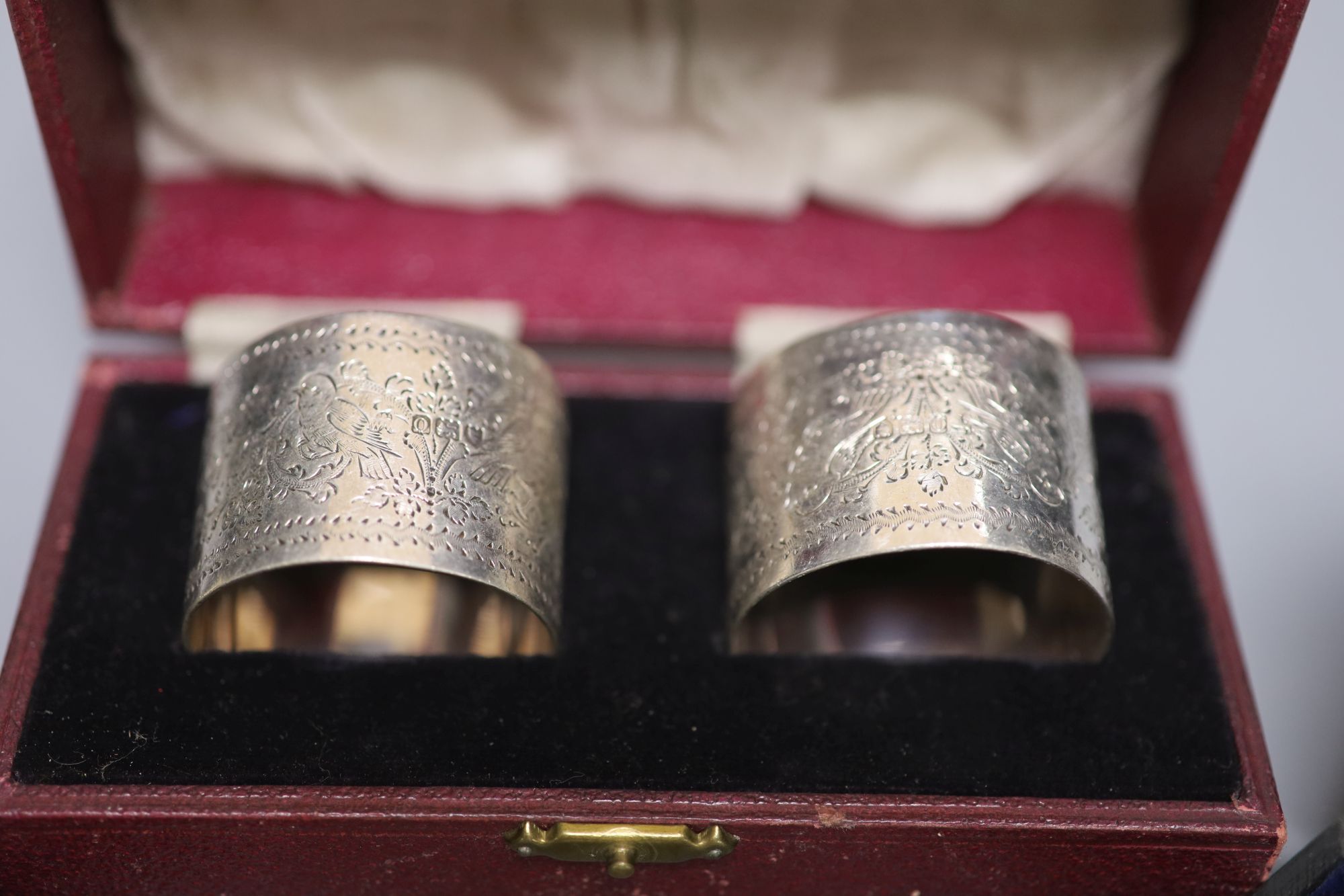Three cased pairs of Edwardian and later silver napkin rings.